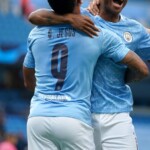 MANCHESTER, ENGLAND - AUGUST 07: Raheem Sterling of Manchester City celebrates with teammates Gabriel Jesus and Phil Foden after scoring his team's first goal during the UEFA Champions League round of 16 second leg match between Manchester City and Real Madrid at Etihad Stadium on August 07, 2020 in Manchester, England. (Photo by Dave Thompson/Pool via Getty Images)